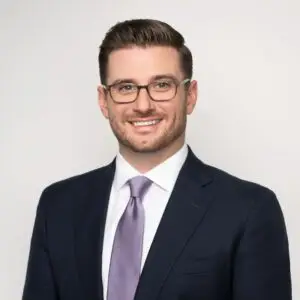 Christopher Horvath, CFP, Managing Director at TAIKO, smiling in a professional suit with a tie, representing investment management leadership and expertise.